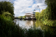 A landscape view of Central Hall from across the lake on Campus West in the summer